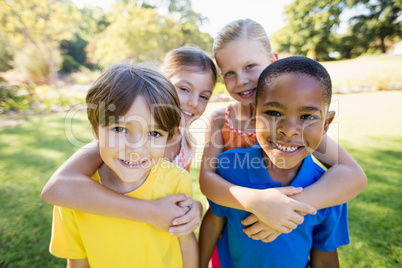 Portrait of children holding each other and smiling