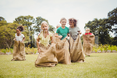 Children enjoying and doing a bag race