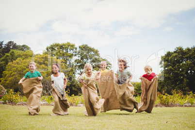 Children enjoying and doing a bag race