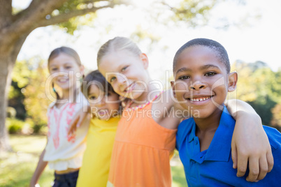 Portrait of children holding each other and smiling