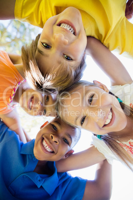 Bottom view of children holding each other and smiling