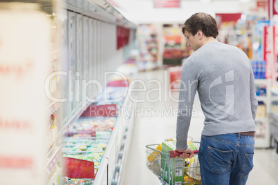 Rear view of man doing grocery shopping