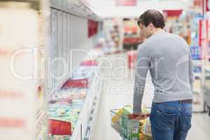 Rear view of man doing grocery shopping