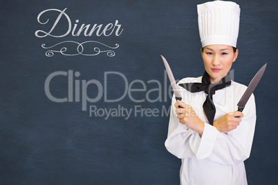 Composite image of confident female cook holding knives in kitchen