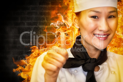 Composite image of portrait of smiling female cook gesturing thumbs up