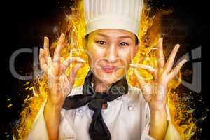 Composite image of closeup of a smiling female cook gesturing okay sign
