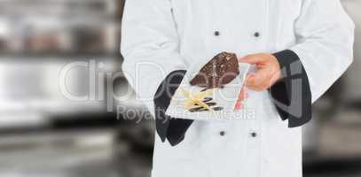 Composite image of close up on a chef holding a chocolate cake
