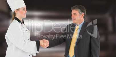 Composite image of businessman and female chef shaking hands