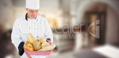 Composite image of friendly chef holding a bread basket