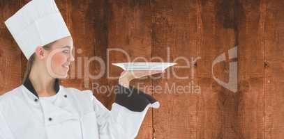 Composite image of woman chef holding a plate