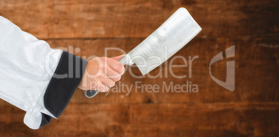 Composite image of chef hand holding a knife