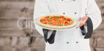 Composite image of close up on a chef presenting a pizza