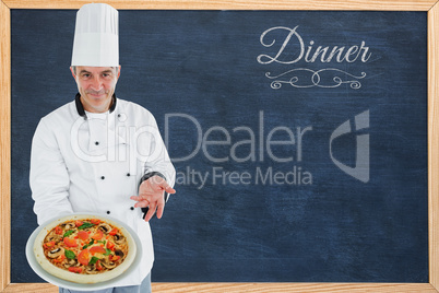 Composite image of chef displaying delicious pizza