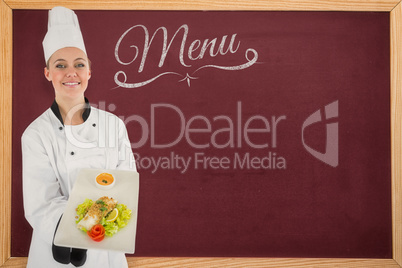 Composite image of woman chef smiling and holding a meal