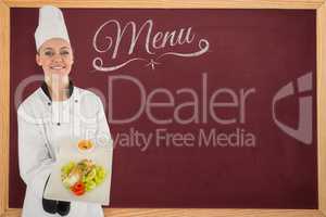 Composite image of woman chef smiling and holding a meal