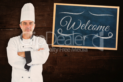 Composite image of serious chef crossed arms