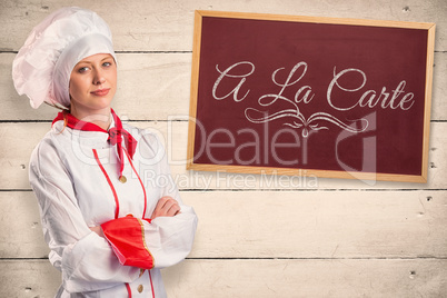 Composite image of pretty chef standing with arms crossed