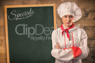 Composite image of pretty chef standing with arms crossed