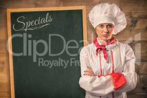 Composite image of pretty chef standing with arms crossed