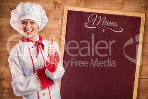Composite image of pretty chef showing thumbs up