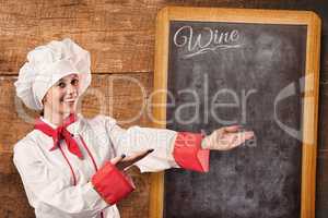 Composite image of pretty chef presenting with hands