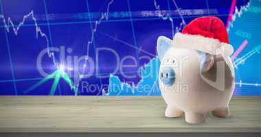 Composite image of image of money-box with christmas hat