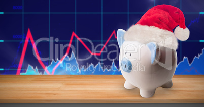 Composite image of image of a money-box with christmas hat