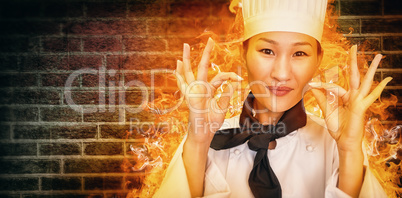 Composite image of closeup of a smiling female cook gesturing okay sign