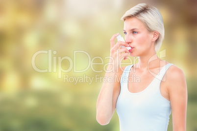 Composite image of blonde woman taking her inhaler