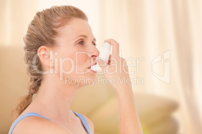 Composite image of woman using inhaler for asthma