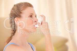 Composite image of woman using inhaler for asthma