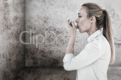 Composite image of beautiful blonde using an asthma inhaler