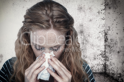 Composite image of close-up of woman blowing nose into tissue