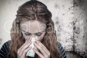 Composite image of close-up of woman blowing nose into tissue