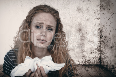 Composite image of portrait of sick woman holding paper tissue