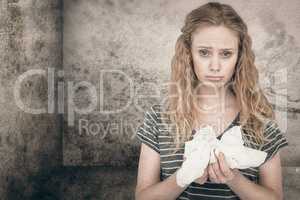 Composite image of sick blonde woman holding paper tissue