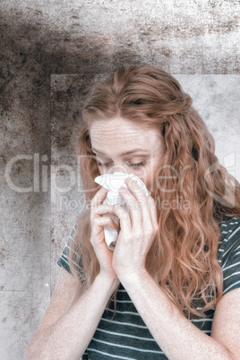 Composite image of sick blonde woman blowing her nose