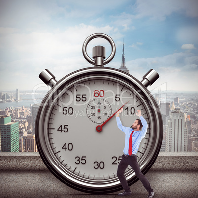 Composite image of focused bending businessman pushing while looking up