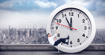 Composite image of businessman pulling rope while sitting on cube