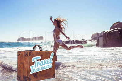 Composite image of beautiful smiling woman in white bikini skipping on the beach