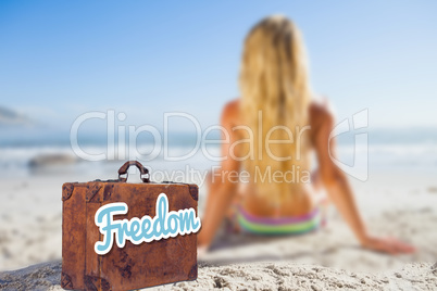 Composite image of old suitcase with the message freedom