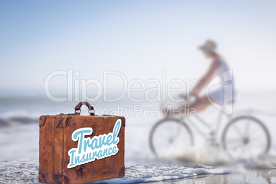 Composite image of travel insurance message on an old suitcase