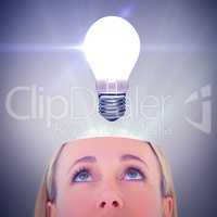 Composite image of close up of blonde woman looking up