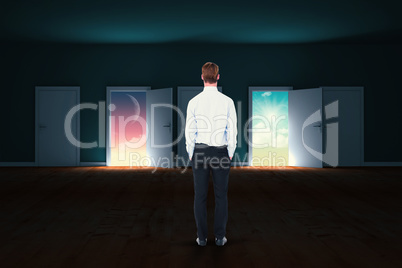 Composite image of rear view of businessman with hands in pockets
