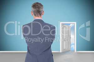 Composite image of rear view of businessman