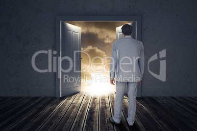 Composite image of rear view of businessman walking on white background