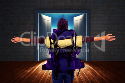 Composite image of rear view of a hipster woman with arms outstretched