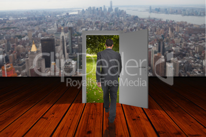 Composite image of businessman walking