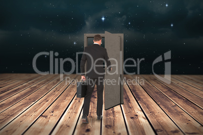Composite image of businessman walking with his briefcase