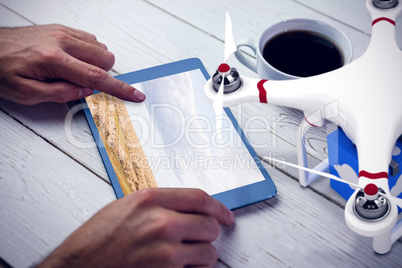 Composite image of a drone bringing a blue cube